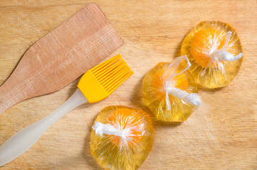 Eggs in a plastic bag are ready to be poached while cooking eggs bededict for brunch.