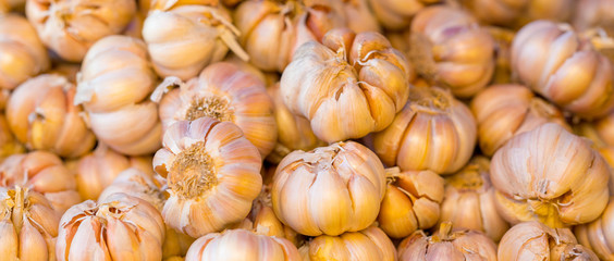 A stack of garlic cloves for sale at market