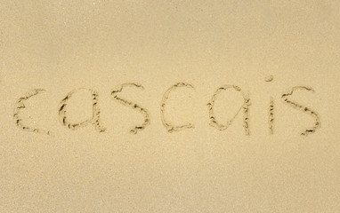 Inscription on wet sand Cascais. 