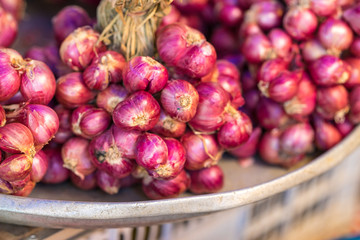 A stack of red onion for sale at market