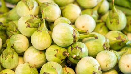 A stack of green eggplant for sale at market - thai eggplant