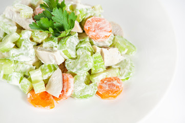 Fresh delicious healthy salad with celery, carrot and meat on white