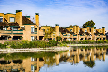 Fototapeta na wymiar Apartment buildings on the shoreline of Belmont Channel, Redwood shores, California