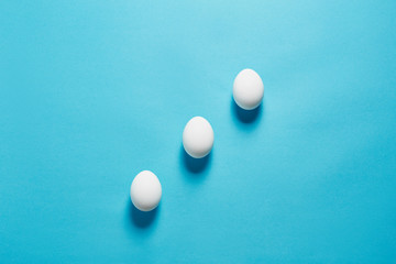 White egg easter on the blue background in center. Design, visual art, minimalist top view copy space