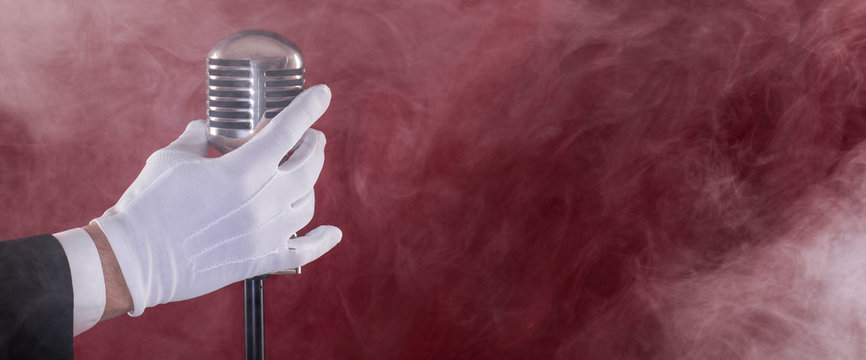 vintage microphone in smoke on red stage