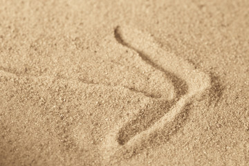 arrow sign on sandy background