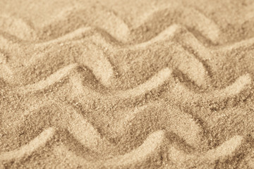 Fototapeta na wymiar wave pattern on sand background texture