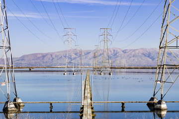 High voltage electricity towers in south San Francisco Bay, Mission peak in the background,...