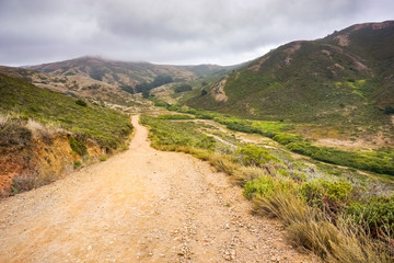 Fototapeta na wymiar Valley road in the Headlands area on a foggy summer day, Golden Gate National Recreation Area, Marin County, California