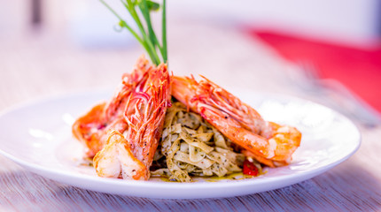Red shrimps with green organic pasta, fine dining set