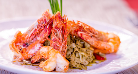Red shrimps with green organic pasta, fine dining set