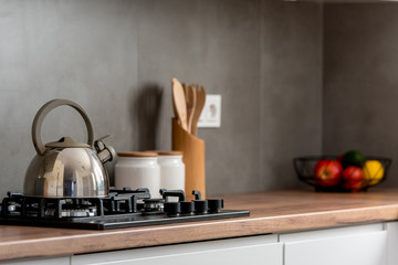 Obraz na płótnie Canvas Minimal white kitchen interior with wooden countertop. Real photo