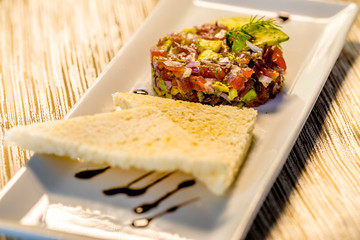 Fresh Tuna Tartare on a white plate with toast, Fine dining set