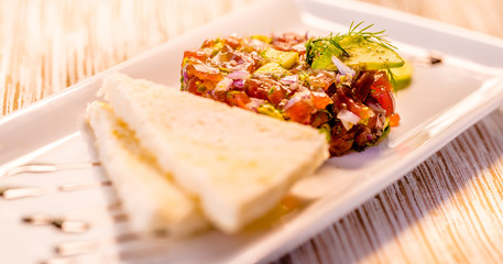 Fresh Tuna Tartare on a white plate with toast, Fine dining set