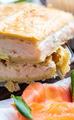Salmon pie and fresh cheese (puff pastry). With natural ingredients. Home and rustic appearance.