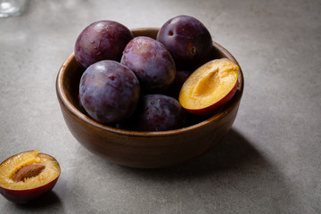Fresh plums in bowl