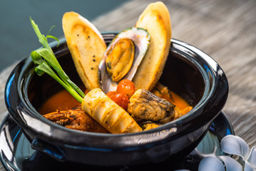 Spicy seafood Soup in a bowl, Thai style fine dining cuisine