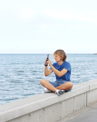 Teenage boy typing text message.Using smart phone.