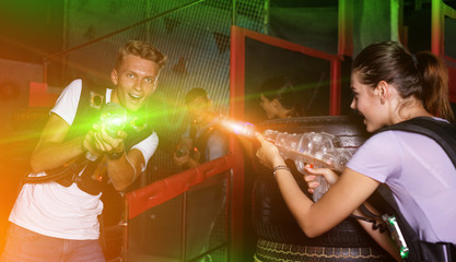 Positive guy holding laser guns and took aim during laser tag ga