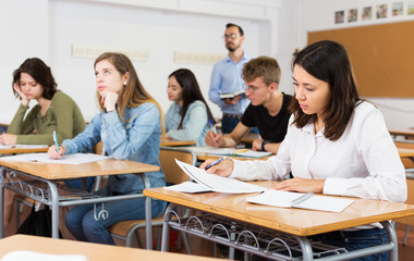 Fototapeta premium Girl writing test in classroom