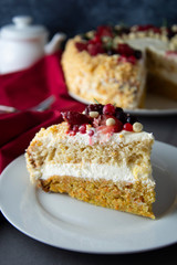 Vegan delicious carrot and orange cake decorated with berries. Healthy dessert. Grey background. Piece of cake.