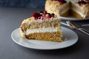 Vegan delicious carrot and orange cake decorated with berries. Healthy dessert. Grey background. Piece of cake.