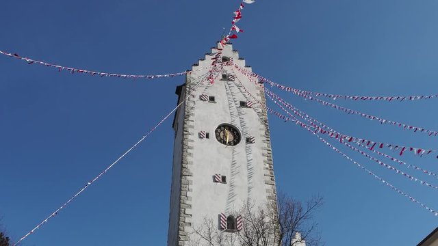 Pfullendorf, Germany. The old tower Oberes part of the ancient medieval fortifications of the city. Small fabric flags waving during the carnival