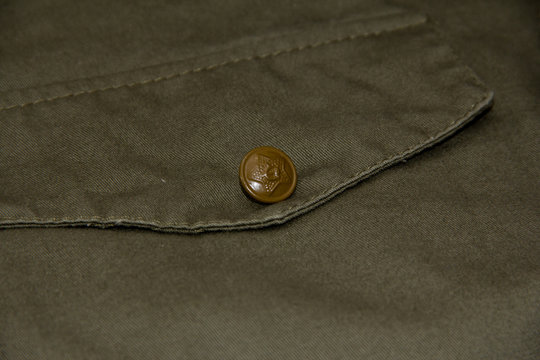Pocket on the tunic of a Soviet soldier with a star on the button.