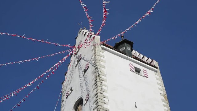 Pfullendorf, Germany. The old tower Oberes part of the ancient medieval fortifications of the city. Small fabric flags waving during the carnival