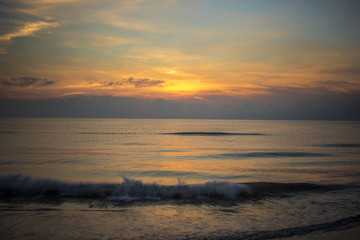 A sunset in a beach in a darkness clouds 