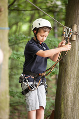 Young teenage boy in a rope park