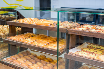 bakery products on display against the background of ovens in the bakery