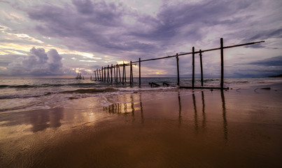 Beautiful sunset with old wooden bridge at Khao Pilai in Phang- Nga Province, Thailand