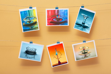 modern art, photo of splash water and paints hanging in rows on a linen thread on stationery clips on a a pastel colored background, interior design