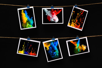 modern art, photo of splash water and paints hanging in rows on a linen thread on stationery clips on a a black background, stylish interior design