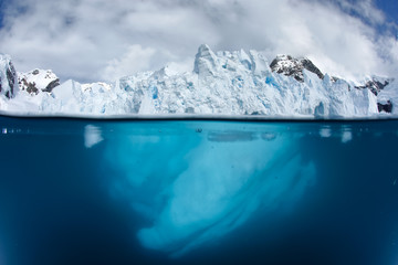 Split view with glacier front above and underwater 