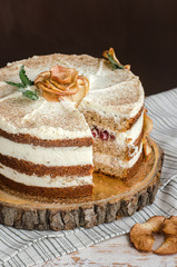 Obraz na płótnie Canvas cake with cream and dried apples on brown background