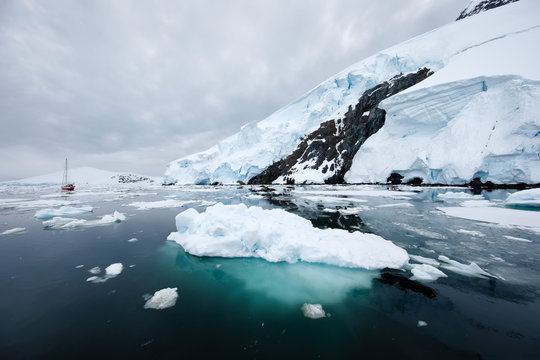 Yacht sails through ice floes