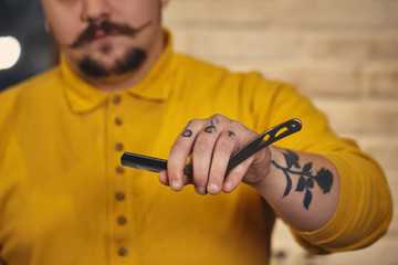Stylish barber man with hairdressing tools in his hands prepare for work