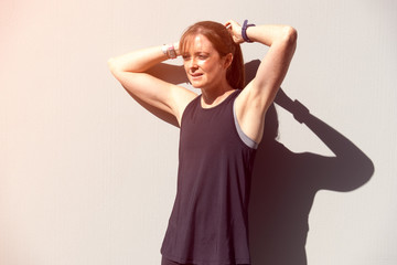 female fitness athlete tieing her hair