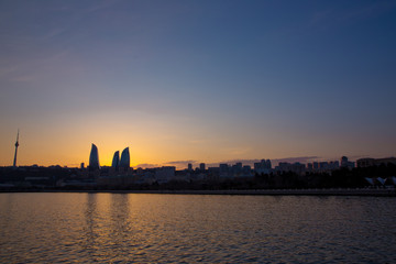Fototapeta na wymiar Sunset of Baku, Azerbaijan . Fire towers in the night