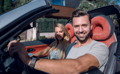 close up.a handsome man driving a luxury car