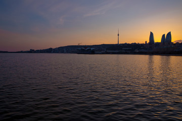 Naklejka premium Sunset of Baku, Azerbaijan . Fire towers in the night