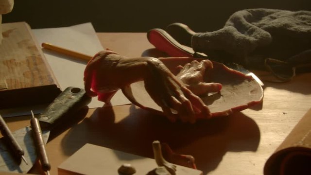 Close up panning shot of horror objects on table in studio of artist / American Fork, Utah, United States