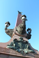 Fototapeta na wymiar Fragment of the rostral column of the Trinity Bridge. St. Petersburg.