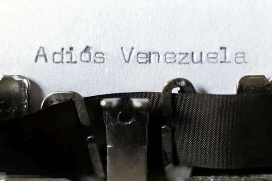 Word "Adios Venezuela" (goodbye Venezuela) typed on typewriter