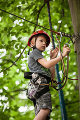 Young teenage boy in a rope park