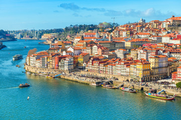Fototapeta na wymiar Cityscape of Porto (Oporto) old town, Portugal. Valley of the Douro River. Panorama of the famous Portuguese city. Popular tourist destination