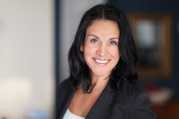 Mature Spanish Businesswoman Smiling At The Camera. At The Office