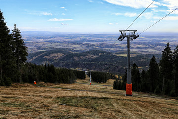 Steep ski slope in the fall with flat land panorama